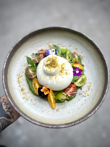 Burrata with heirloom tomatoes and edible flowers