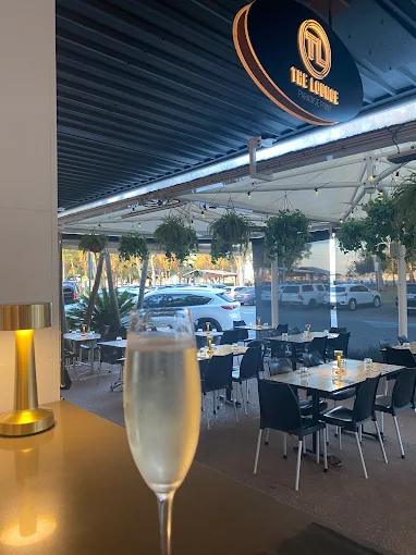 A champagne flute on a terrace table looking out to the water