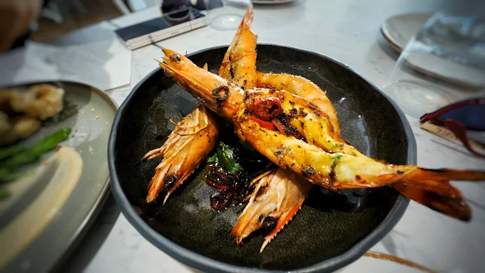 Chargrilled king prawns in a dark bowl