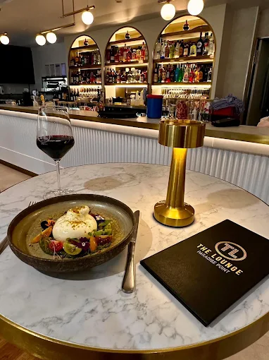 A glass of red wine on a marble bar top
